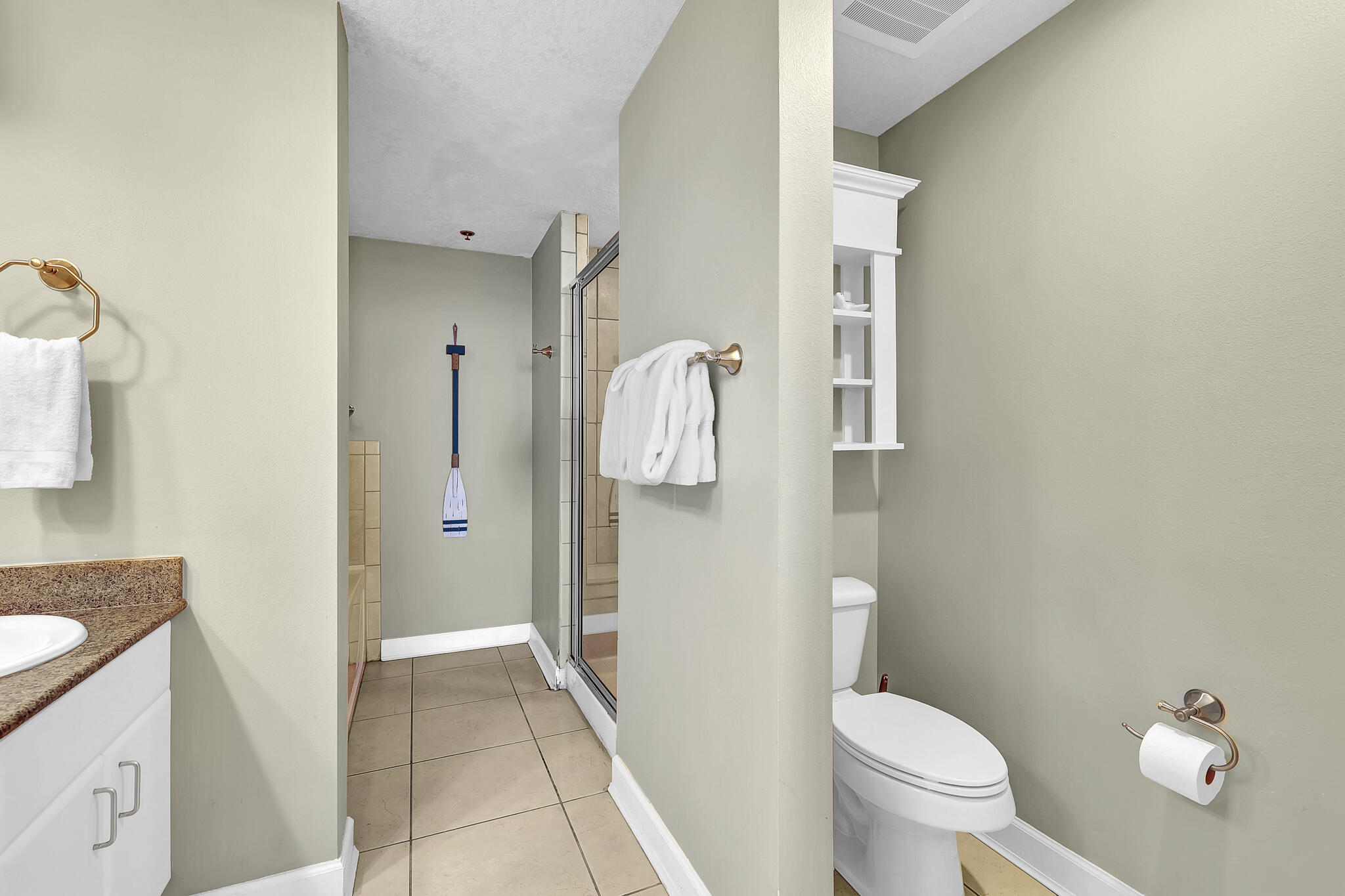 11800 Front Beach Road, Unit 2408 Panama City Beach, FL 32407 - Photo 16 of 42 a bathroom with a granite countertop toilet sink and mirror