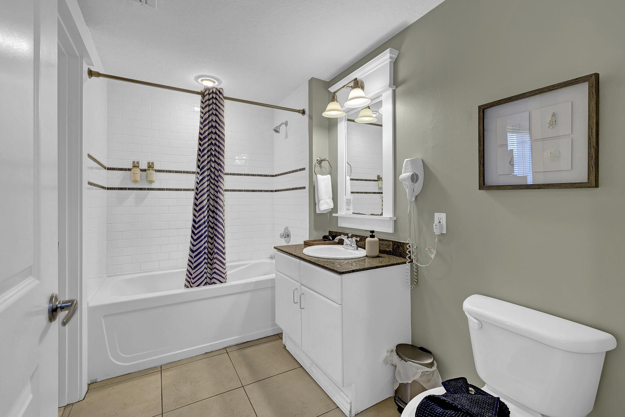 11800 Front Beach Road, Unit 2408 Panama City Beach, FL 32407 - Photo 26 of 42 a bathroom with a granite countertop sink toilet and shower