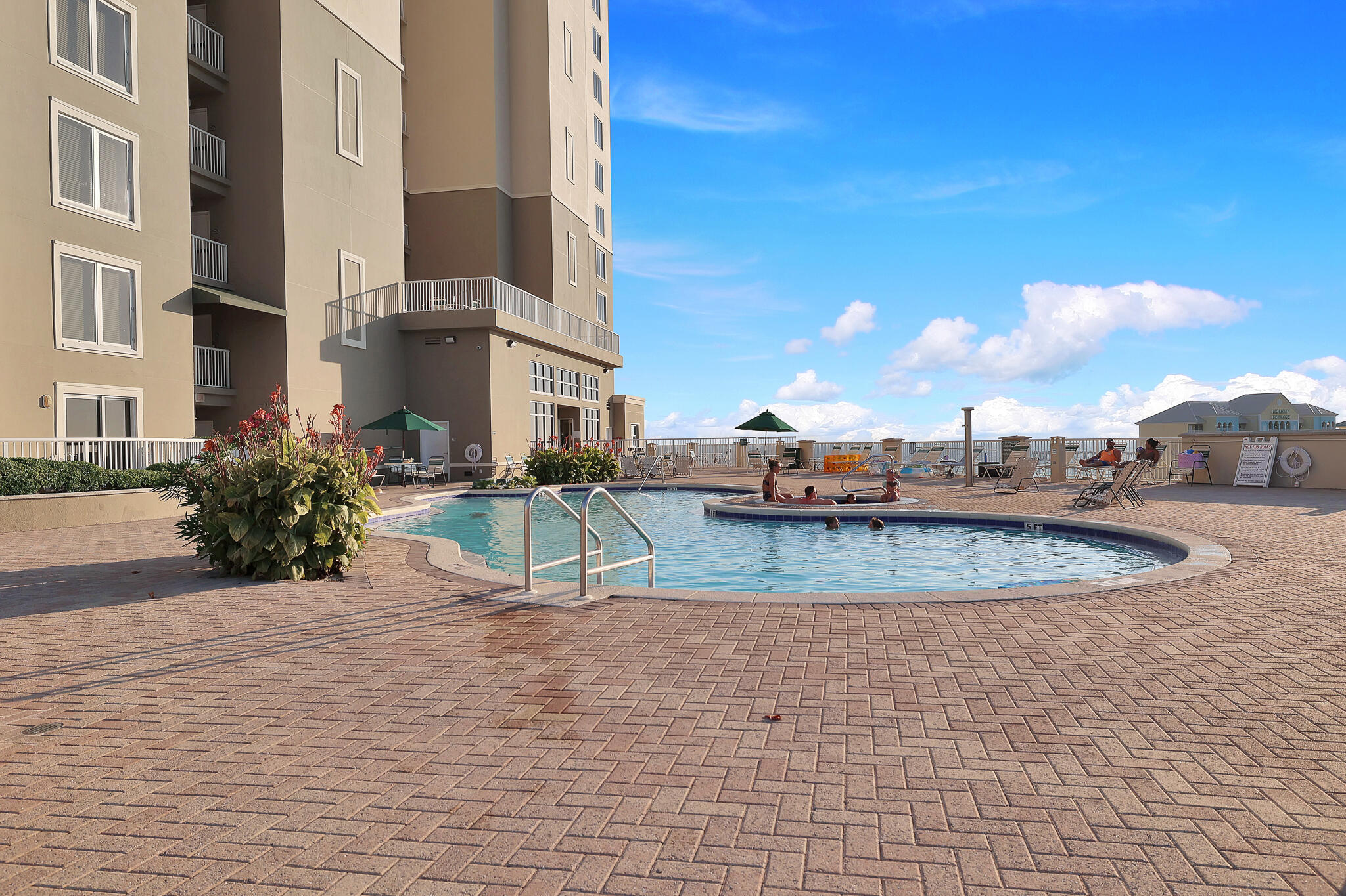11800 Front Beach Road, Unit 2408 Panama City Beach, FL 32407 - Photo 29 of 42 a view of a swimming pool with a patio