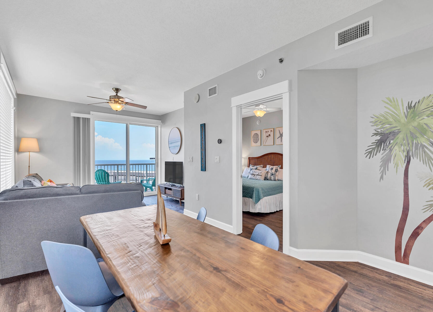 11800 Front Beach Road, Unit 2408 Panama City Beach, FL 32407 - Photo 6 of 42 a dining room with wooden floor and glass door