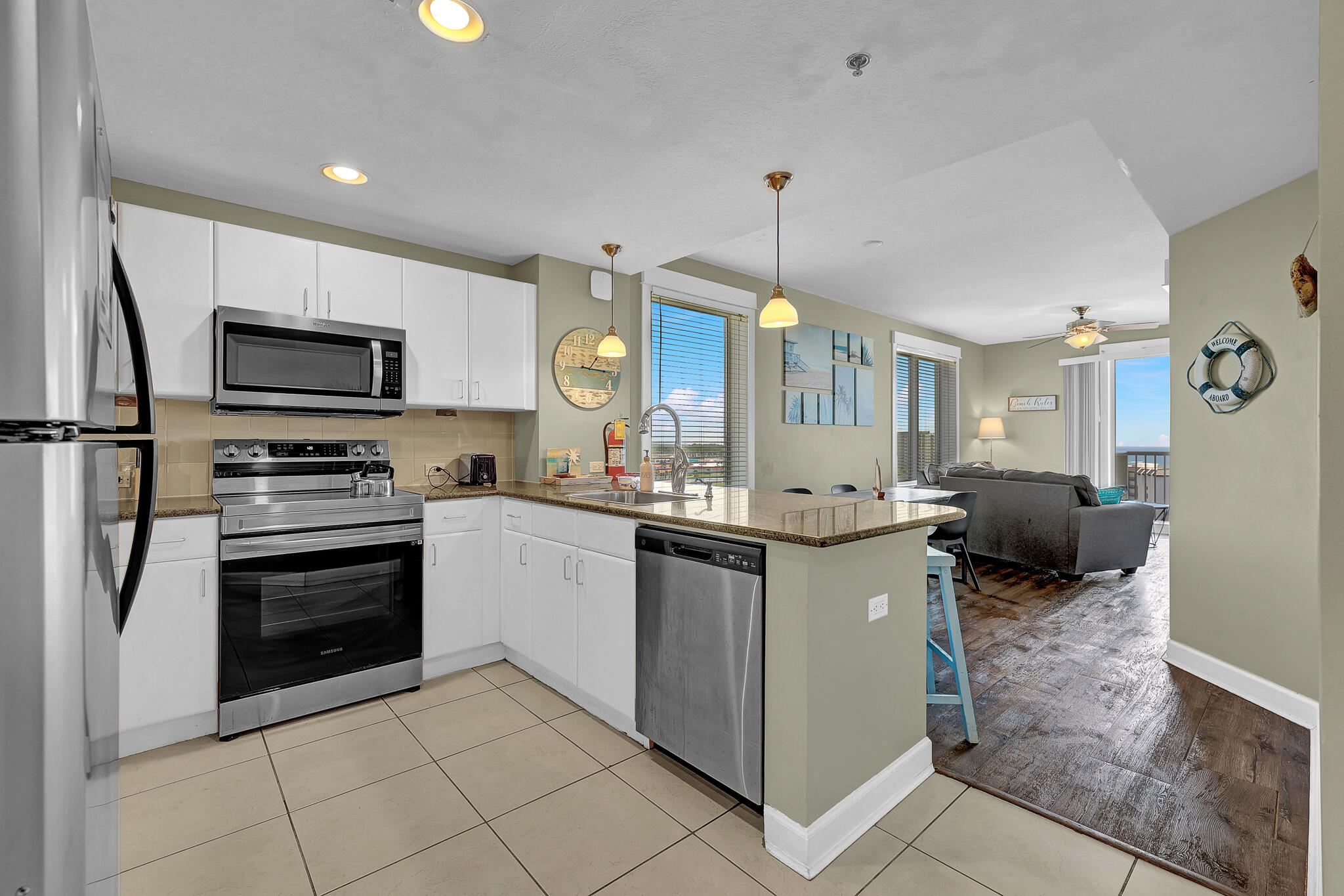 11800 Front Beach Road, Unit 2408 Panama City Beach, FL 32407 - Photo 7 of 42 a kitchen with stainless steel appliances granite countertop a stove top oven a sink and a refrigerator