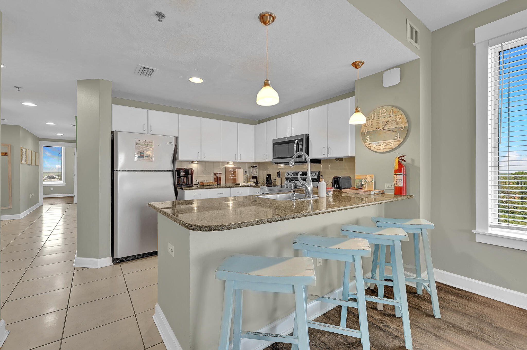 11800 Front Beach Road, Unit 2408 Panama City Beach, FL 32407 - Photo 8 of 42 a kitchen with stainless steel appliances granite countertop a sink and a refrigerator