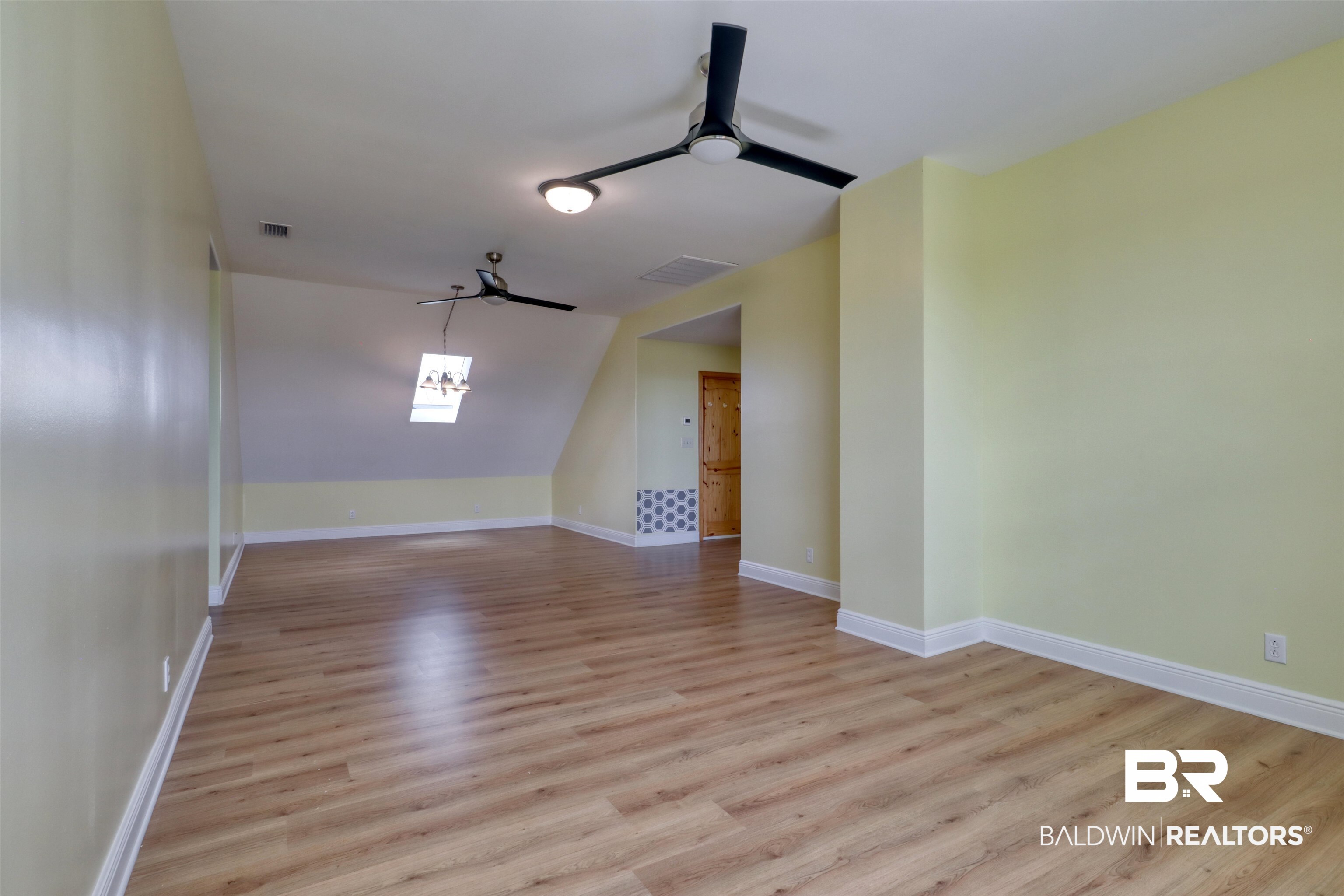 28461 Gardner Road Elberta, AL 36530 - Photo 17 of 46 Unfurnished room featuring ceiling fan, light wood finished floors, and vaulted ceiling
