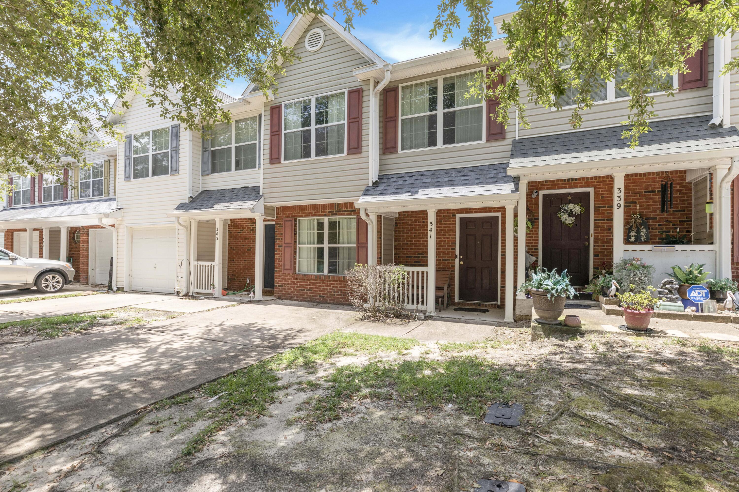 a front view of a house with yard and seating space