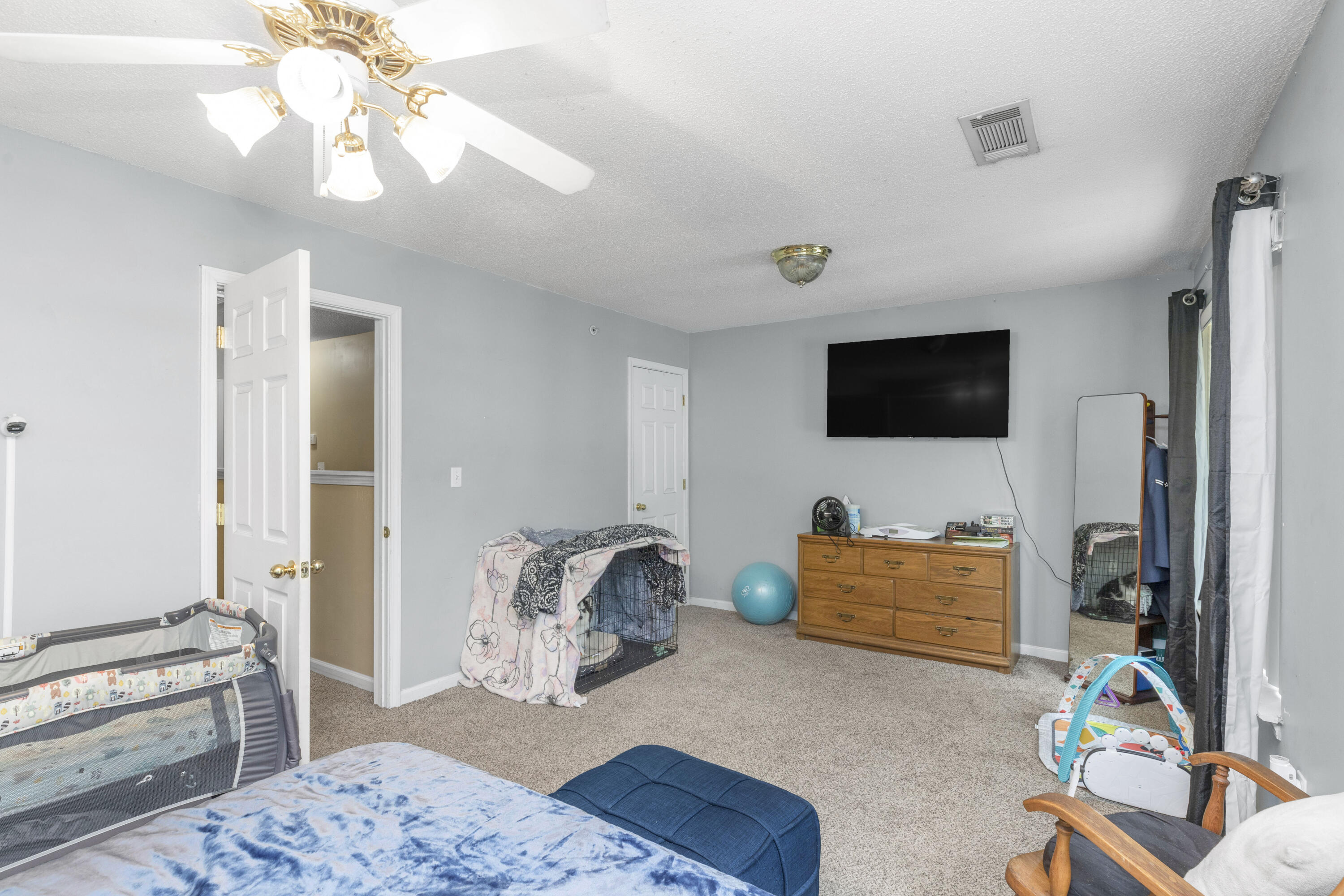 341 Crooked Pine Trail Crestview, FL 32539 - Photo 14 of 27 a bedroom with furniture and a flat screen tv