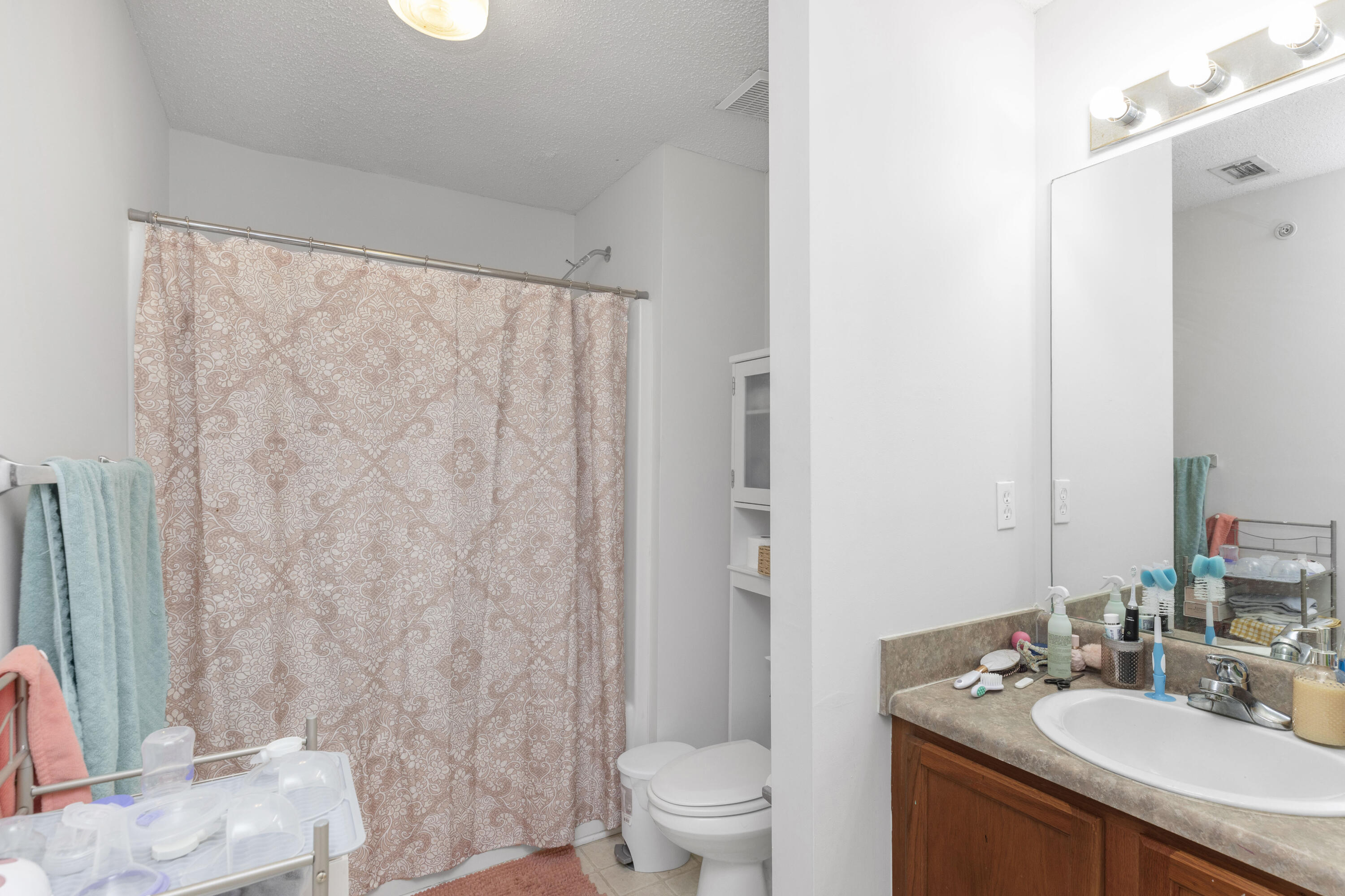 341 Crooked Pine Trail Crestview, FL 32539 - Photo 15 of 27 a bathroom with a granite countertop sink a toilet and a mirror