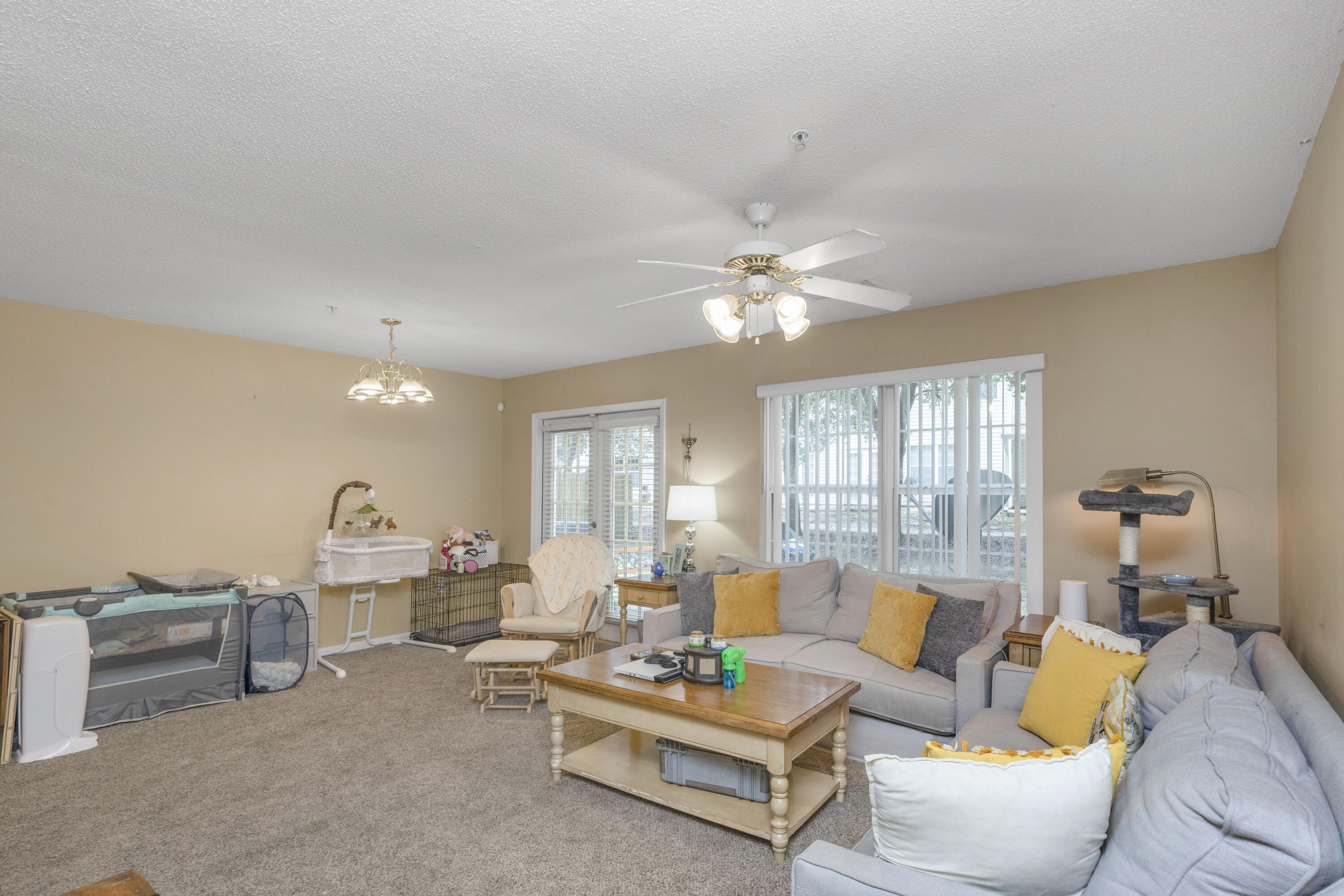 341 Crooked Pine Trail Crestview, FL 32539 - Photo 5 of 27 a living room with furniture and a chandelier