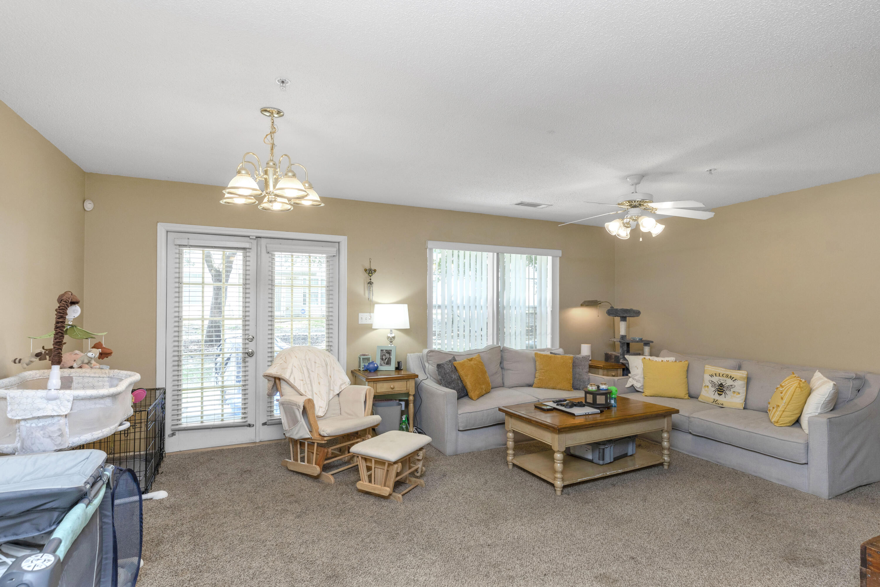 341 Crooked Pine Trail Crestview, FL 32539 - Photo 6 of 27 a living room with furniture and chandelier
