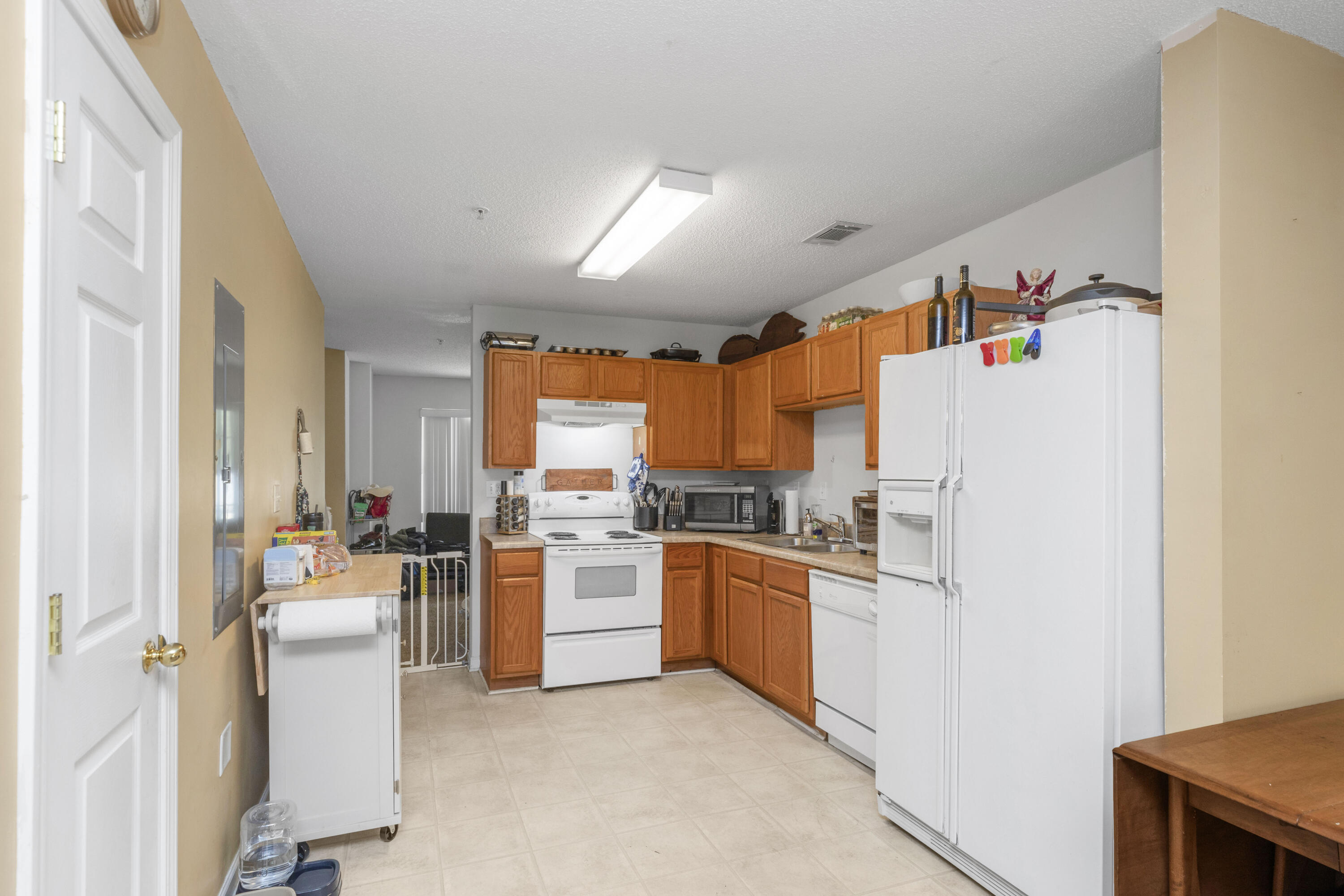 341 Crooked Pine Trail Crestview, FL 32539 - Photo 9 of 27 a kitchen with sink refrigerator and window
