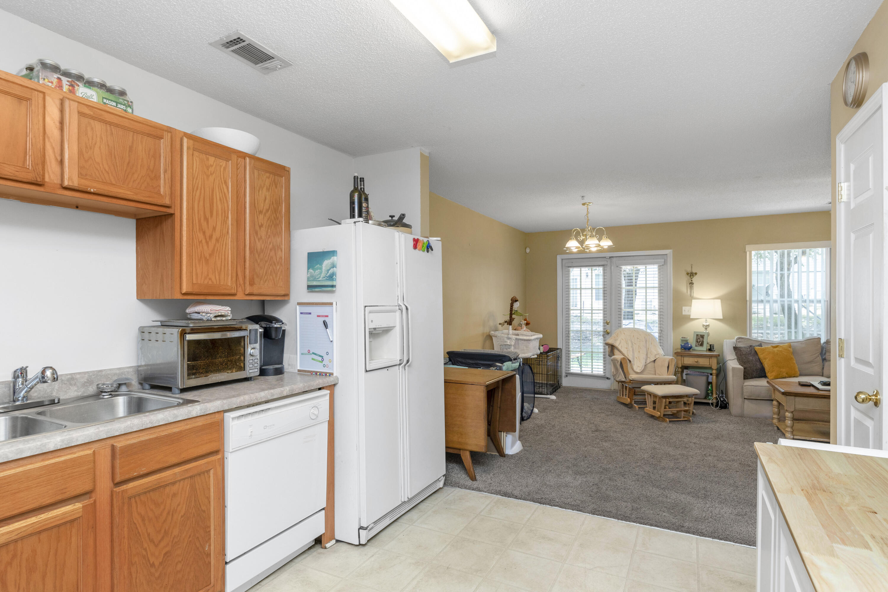 341 Crooked Pine Trail Crestview, FL 32539 - Photo 10 of 27 a kitchen with furniture a large window and a view of living room