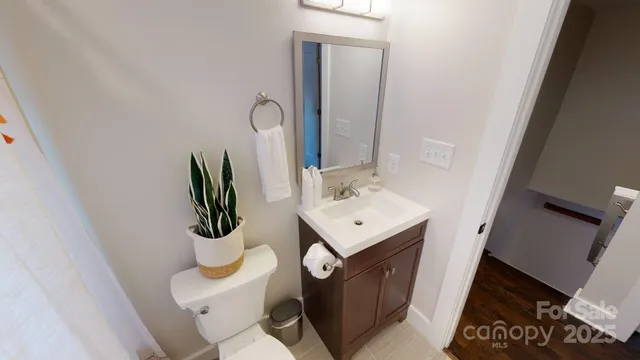 a bathroom with a sink toilet and mirror