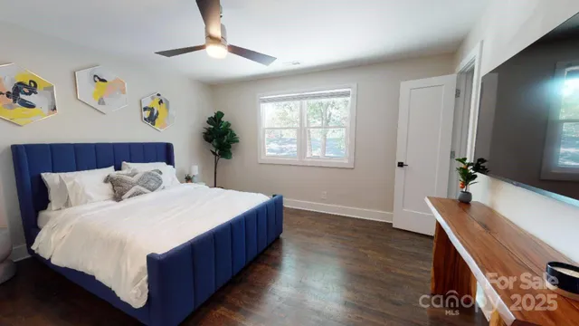 a bedroom with a bed and a flat screen tv