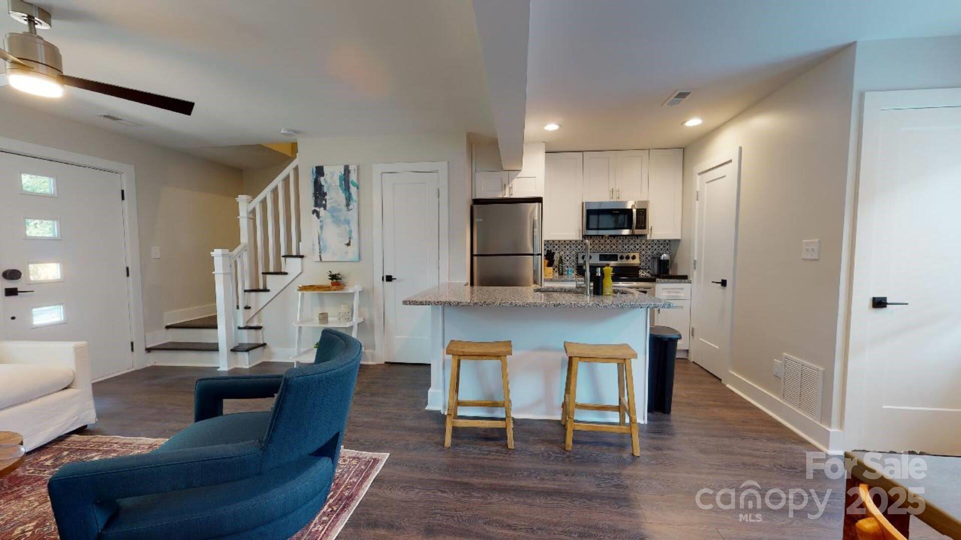 1909 Pegram Street Charlotte, NC 28205 - Photo 35 of 48 a living room with stainless steel appliances kitchen island granite countertop furniture and a wooden floor