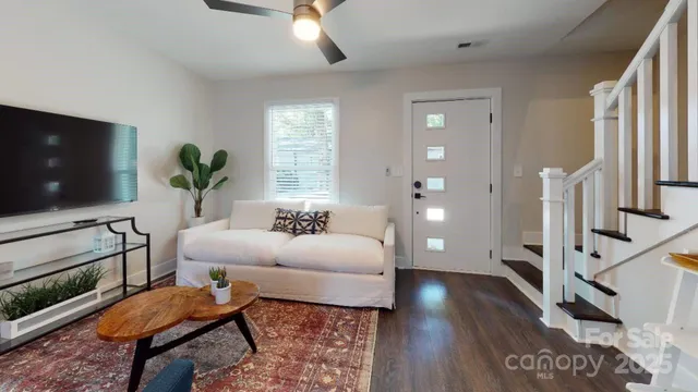 a living room with furniture and a flat screen tv