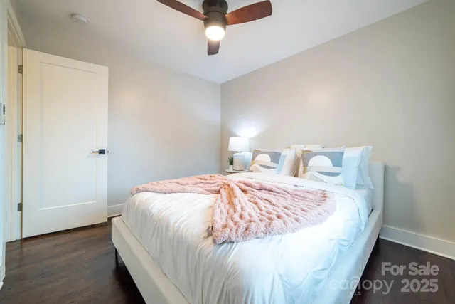 a bedroom with a bed and a ceiling fan