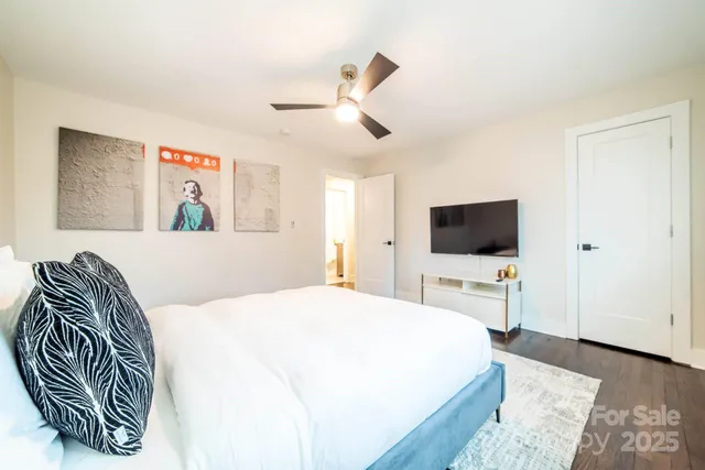 a bedroom with a bed and a flat screen tv