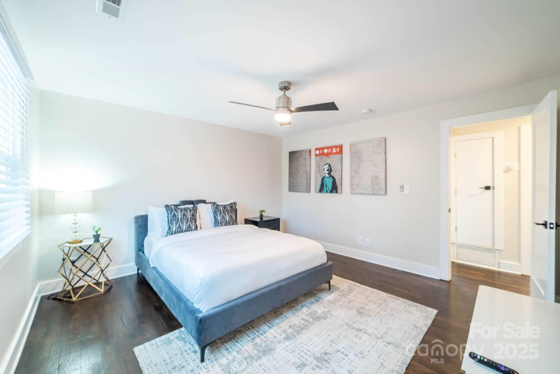 1909 Pegram Street Charlotte, NC 28205 - Photo 42 of 48 a bedroom with a bed rug and wooden floor