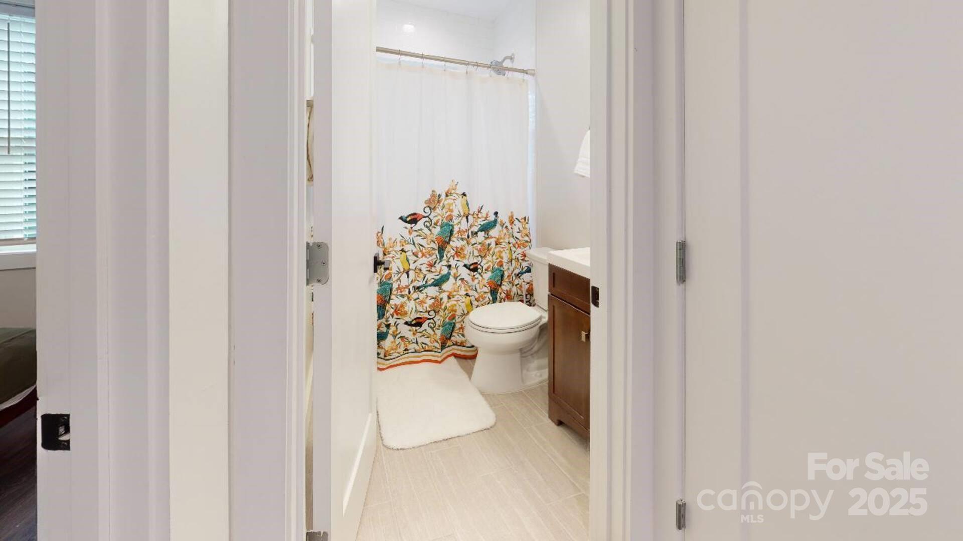 1909 Pegram Street Charlotte, NC 28205 - Photo 6 of 48 a bathroom with a toilet and a shower curtain