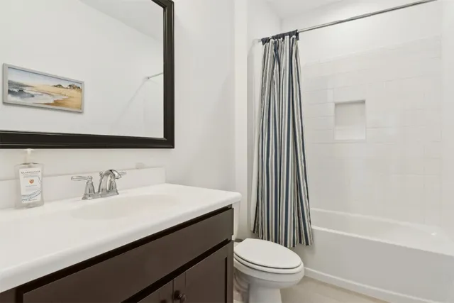 a spacious bathroom with a double vanity sink and mirror