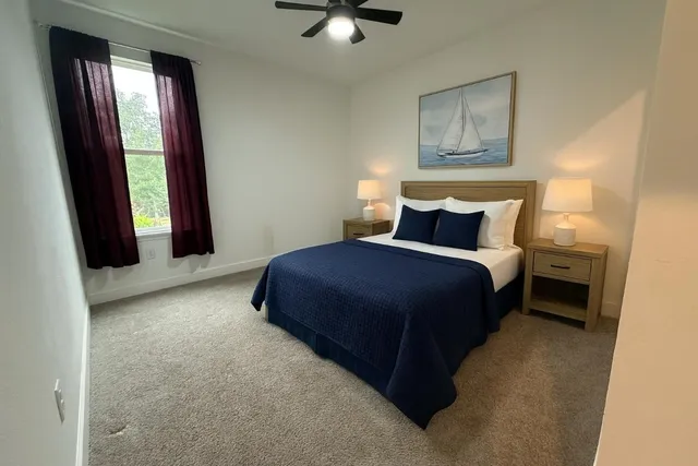 a kitchen with stainless steel appliances granite countertop a stove a sink and a refrigerator with white cabinets