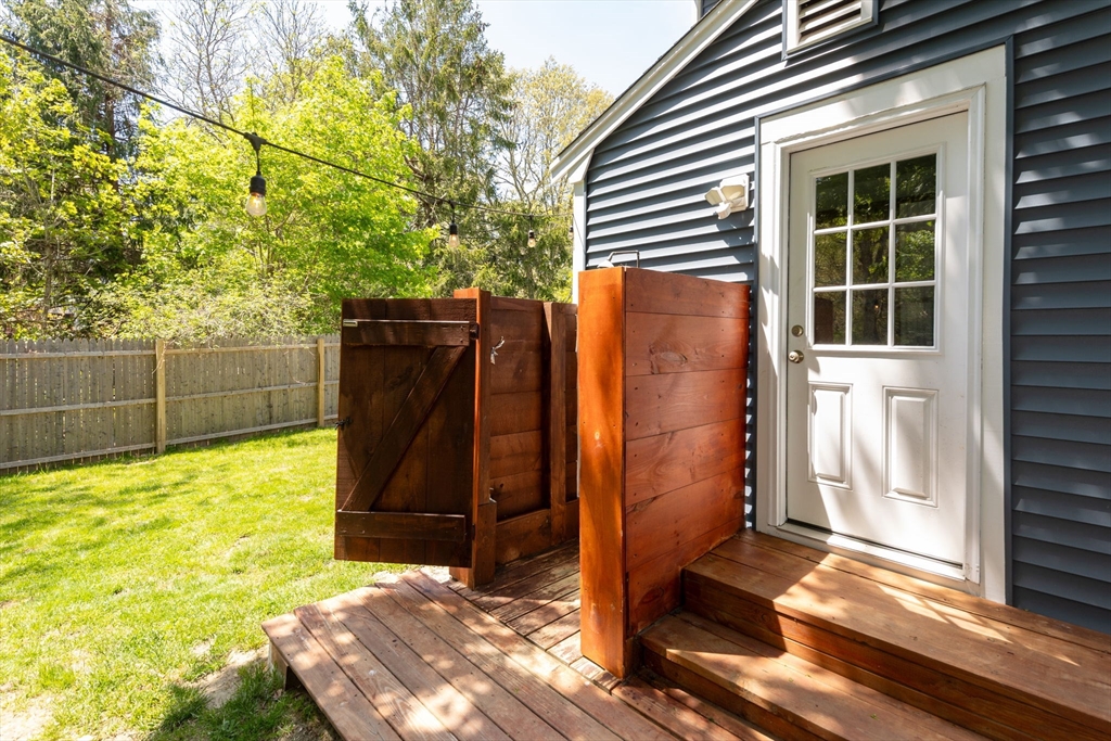 1020 Old Falmouth Road Barnstable, MA 02632 - Photo 10 of 42 a backyard of a house with wooden floor
