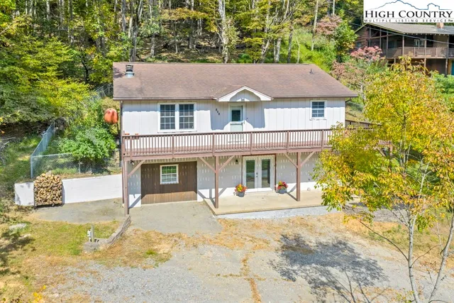 a view of house with outdoor space and sitting area