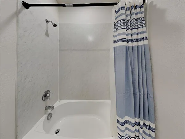 a bathroom with a bathtub and shower