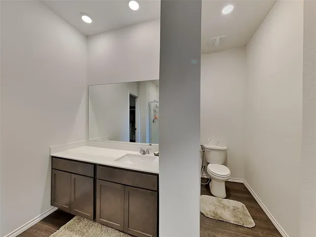a bathroom with a sink a toilet and mirror