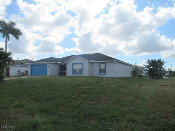 a view of a big yard with wooden fence