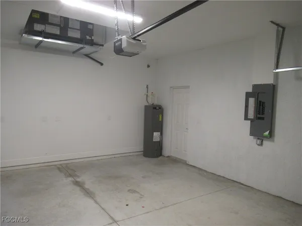 a view of a room with refrigerator and wooden floor