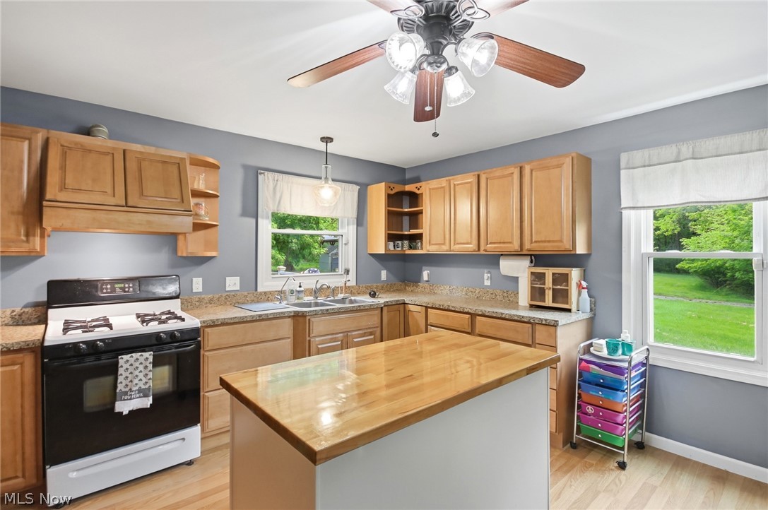2591 Wayland Road Deerfield, OH 44411 - Photo 9 of 46 Kitchen featuring light wood cabinetry and a central island with a wood countertop