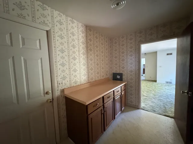 a kitchen with a stove and refrigerator