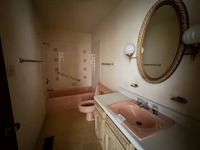 a bathroom with a sink a toilet and a tub