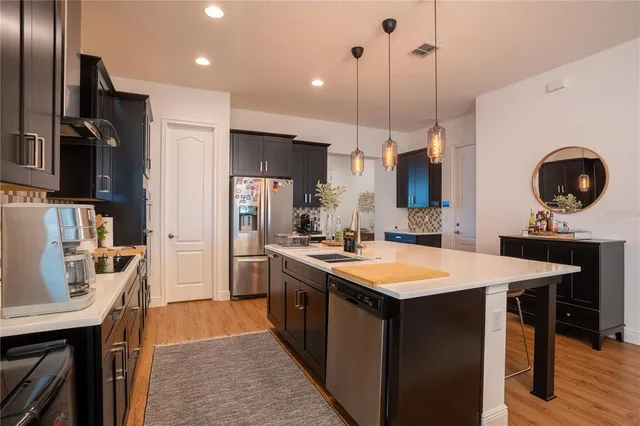 a kitchen with a sink and a mirror
