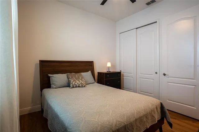 a bathroom with a granite countertop sink a large mirror and a bathtub