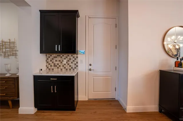 a kitchen with stainless steel appliances kitchen island granite countertop a table chairs sink and cabinets