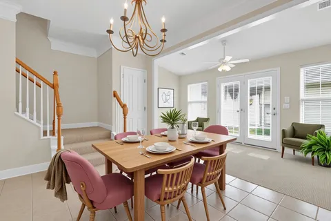 a view of a livingroom with a ceiling fan and window