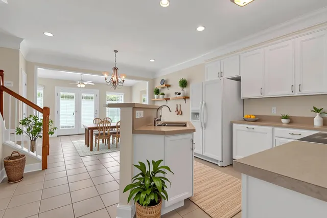 a kitchen with granite countertop a sink a counter top space and stainless steel appliances