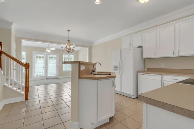 a view of a kitchen with a refrigerator and a sink