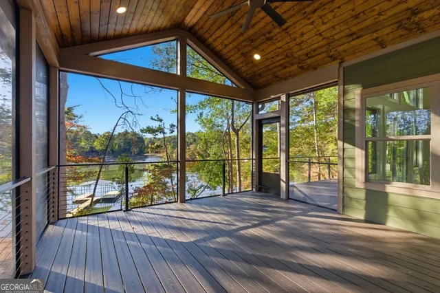 a view of balcony with wooden floor and fence