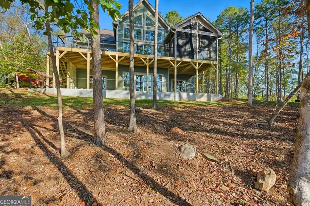 a view of hallway with wooden floor and a window