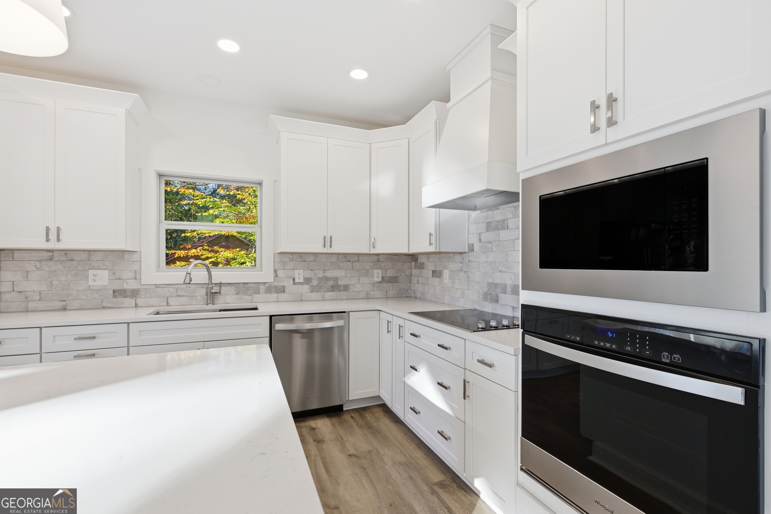 259 West Currahee Street Toccoa, GA 30577 - Photo 21 of 47 a kitchen with stainless steel appliances white cabinets granite counter tops and a stove