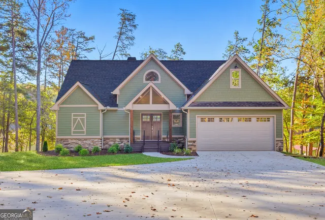 a view of an empty room with wooden floor and windows