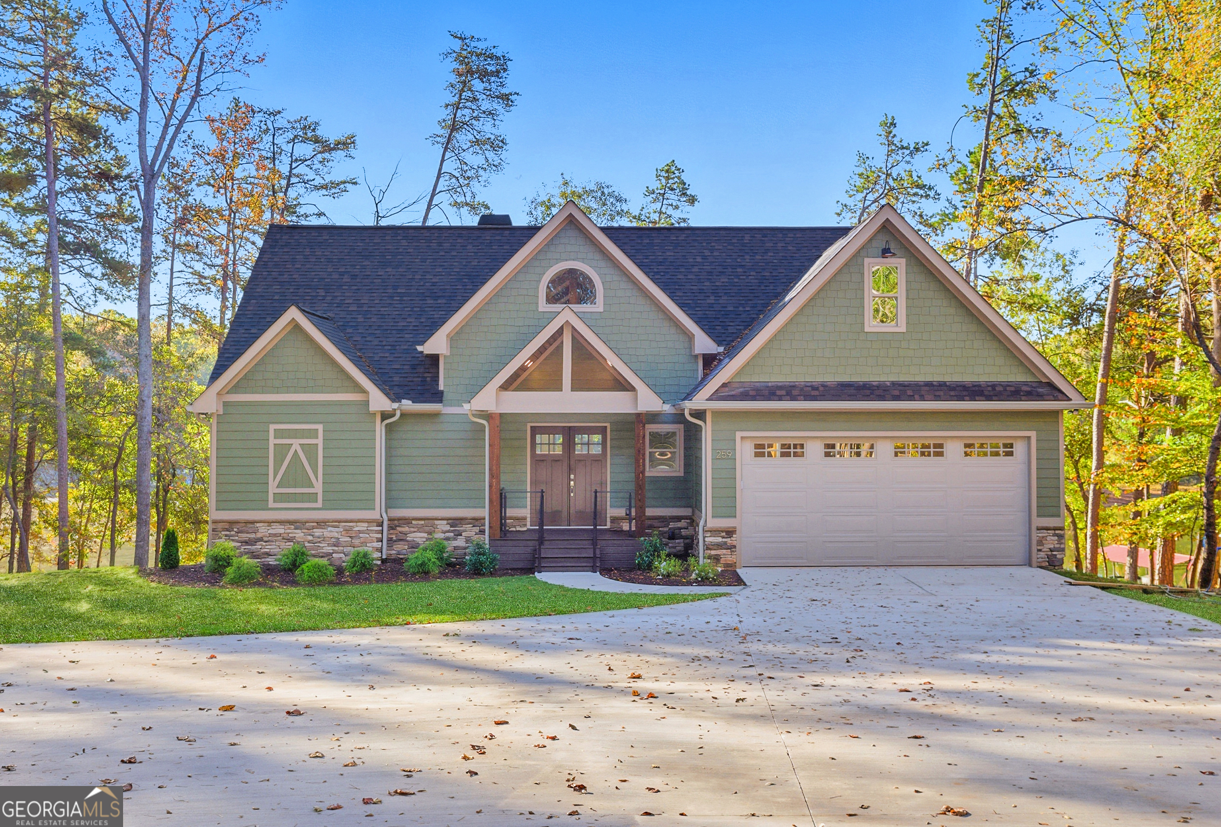 259 West Currahee Street Toccoa, GA 30577 - Photo 3 of 47 a front view of a house with a yard and garage