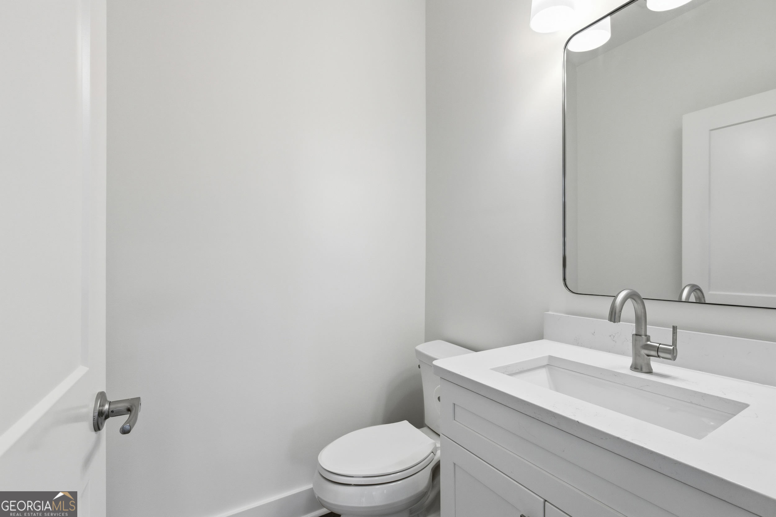 259 West Currahee Street Toccoa, GA 30577 - Photo 31 of 47 a bathroom with a toilet a sink and mirror