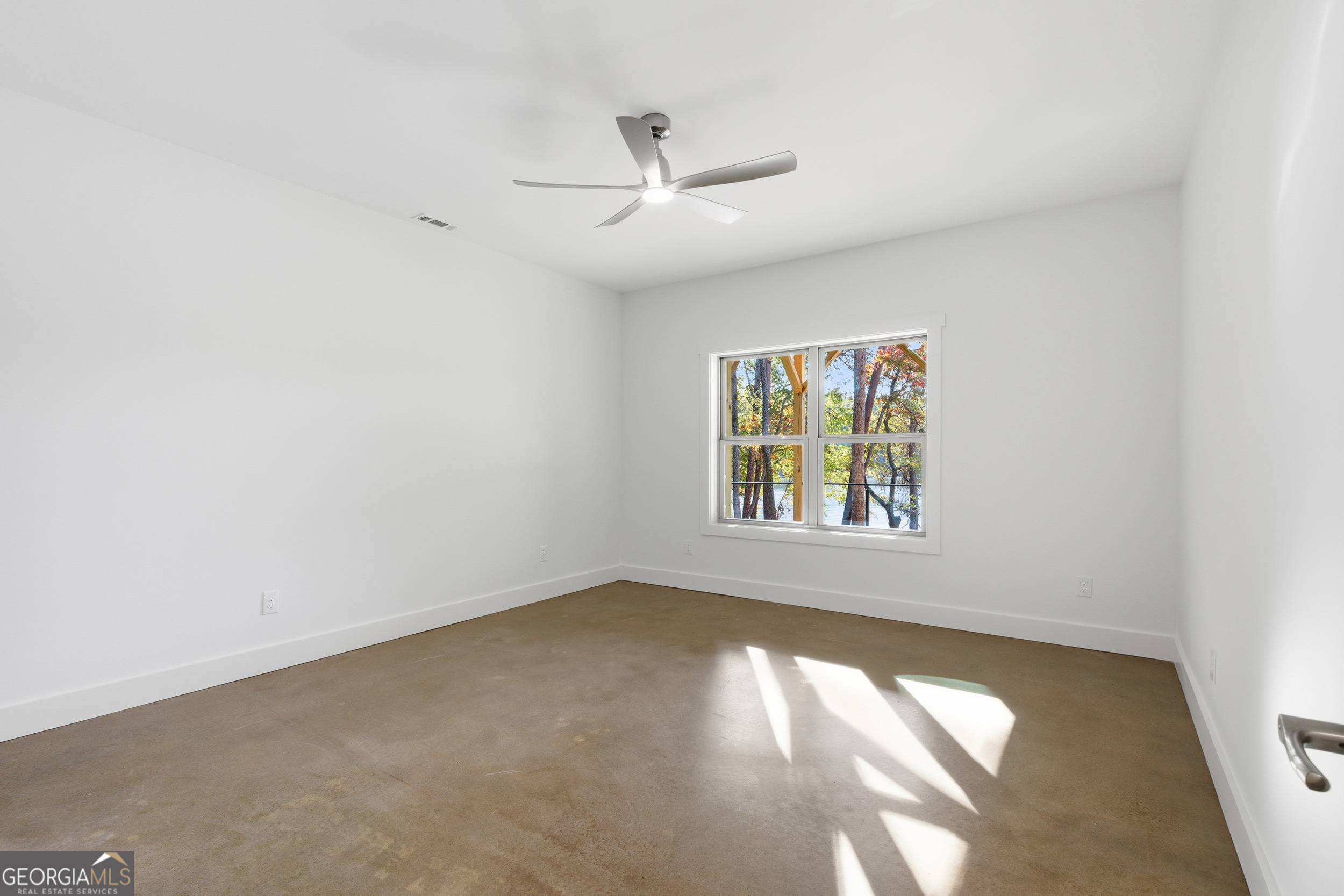 259 West Currahee Street Toccoa, GA 30577 - Photo 38 of 47 an empty room with a window and a ceiling fan