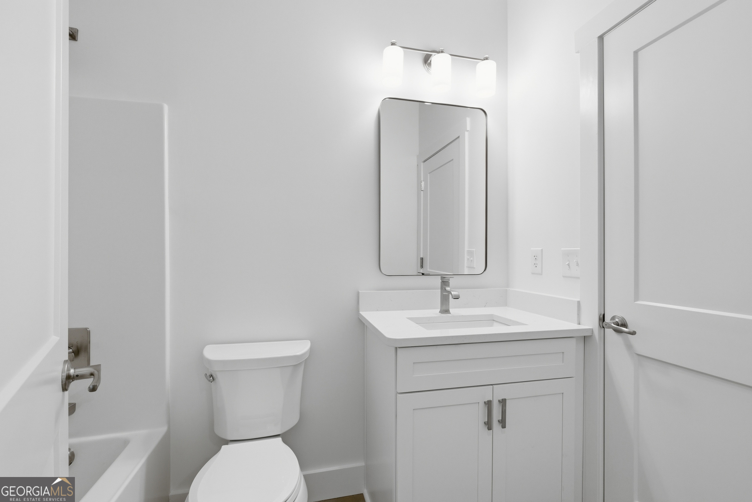 259 West Currahee Street Toccoa, GA 30577 - Photo 40 of 47 a bathroom with a toilet sink and mirror