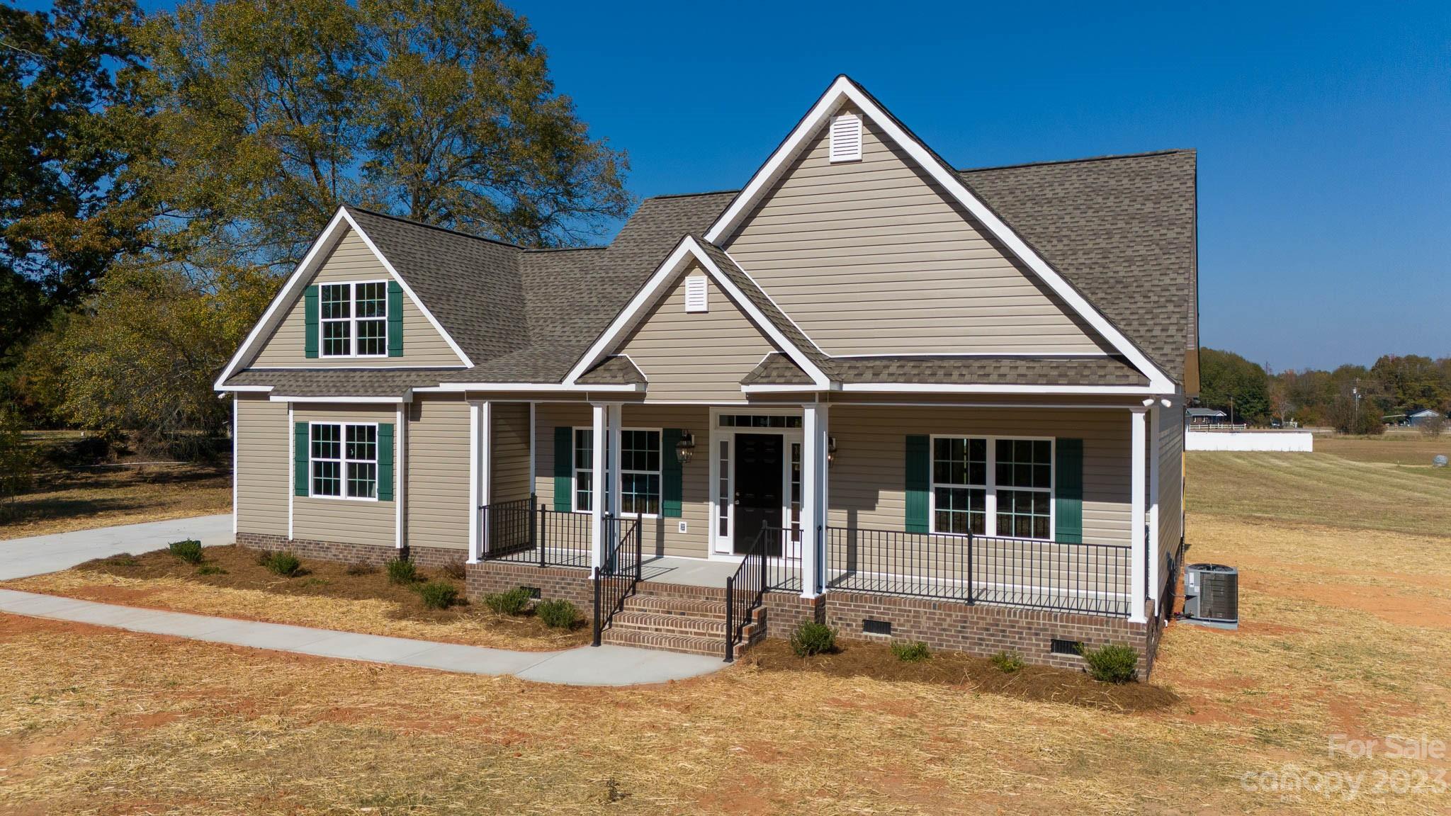 4639 Simpson Road Edgemoor, SC 29712 - Photo 1 of 30 a front view of a house with basket ball court and potted plants
