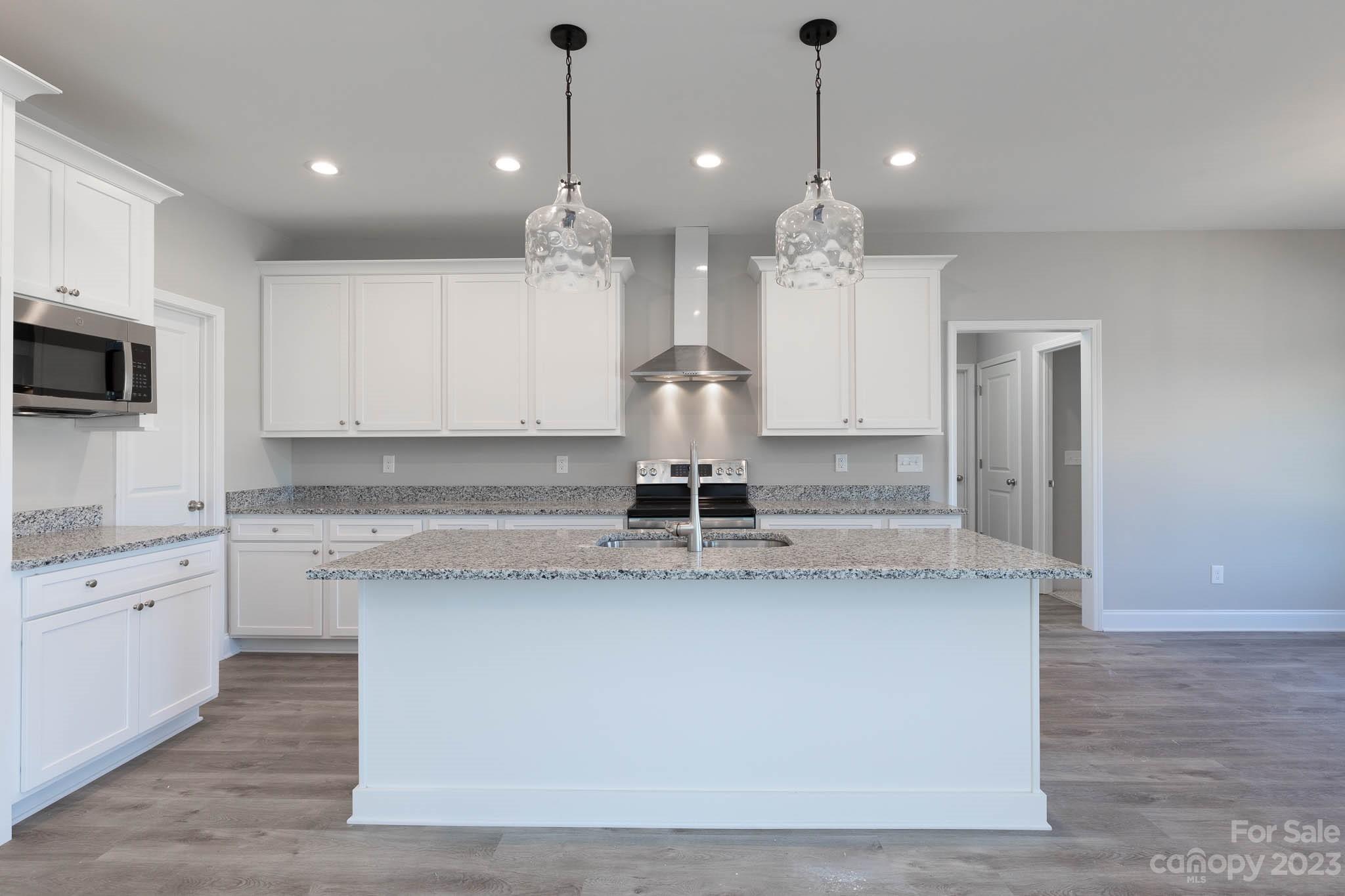 4639 Simpson Road Edgemoor, SC 29712 - Photo 11 of 30 a large kitchen with kitchen island a sink stainless steel appliances and cabinets