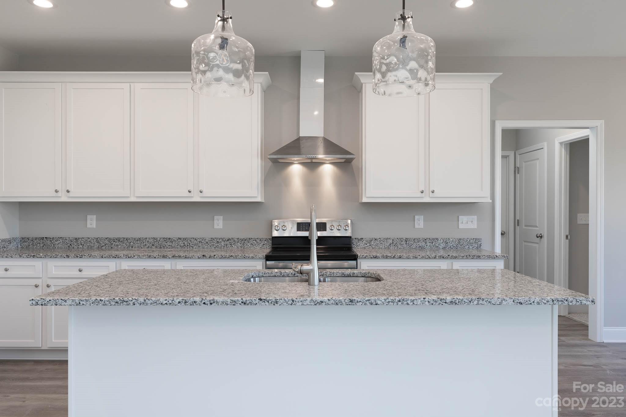4639 Simpson Road Edgemoor, SC 29712 - Photo 12 of 30 a kitchen with a refrigerator and white cabinets
